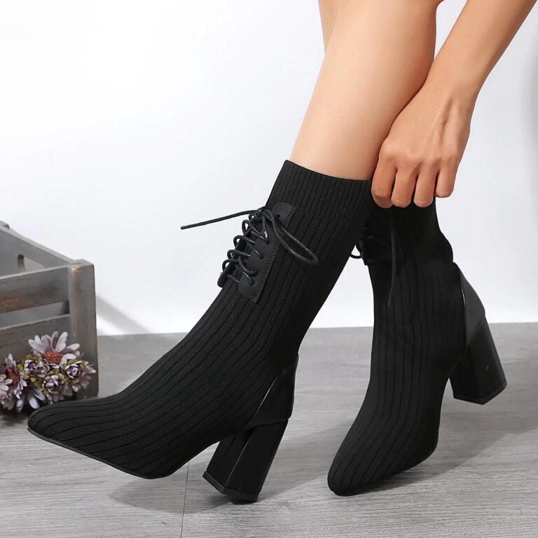 Pair of knitted ankle boots in black, showcasing lace-up design and sturdy sole. Perfect for chic, comfortable everyday wear